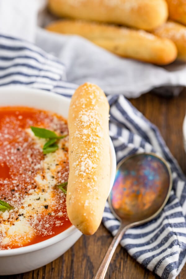 breadstick on the side of bowl of marinara sauce