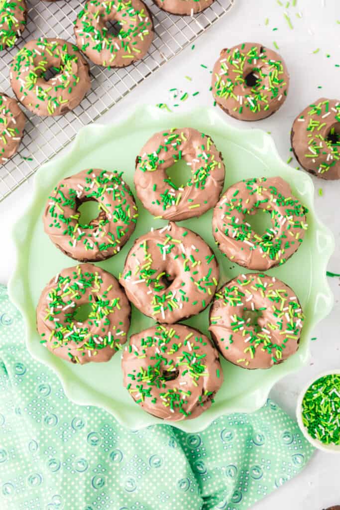 Chocolate Mint Donuts on a serving platter with mint chocolate coating and festive green sprinkles