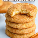 stack of snickerdoodles with the top cookie having a bite taken out
