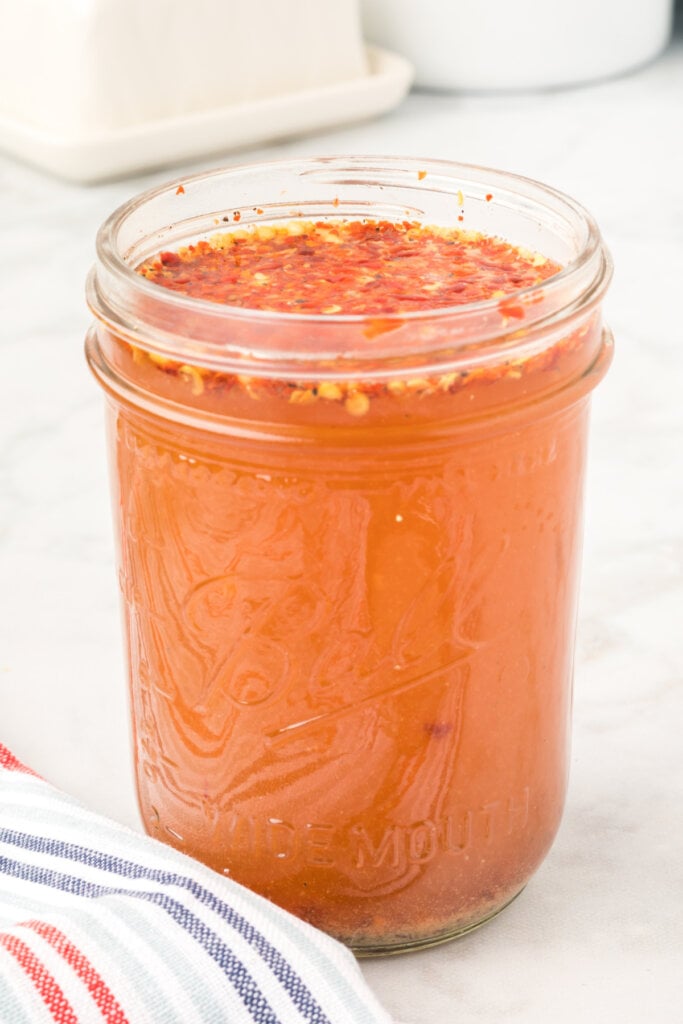 glass jar full of eastern nc vinegar-based bbq sauce