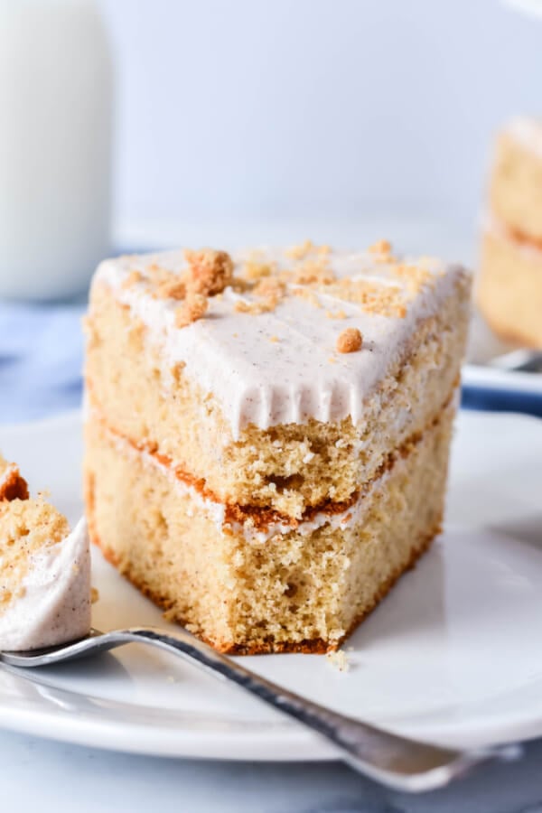 bite of cake on fork laying on plate with cake on plate
