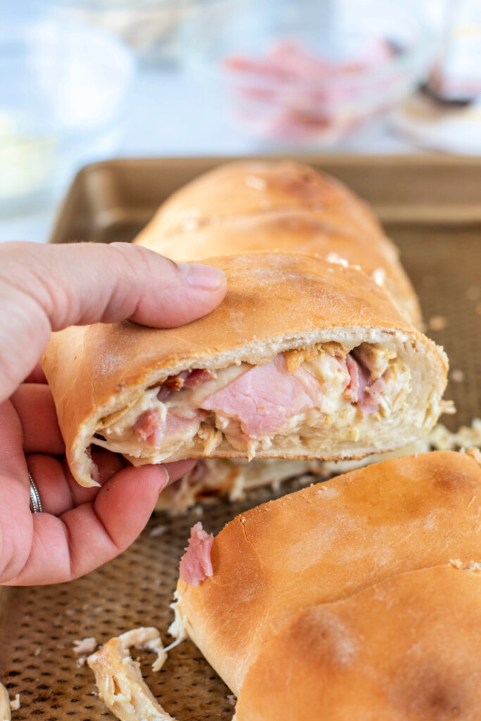 hand holding a stromboli slice