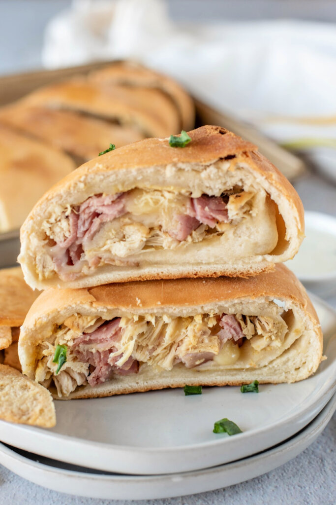 chicken cordon bleu stromboli slices stacked on white plate