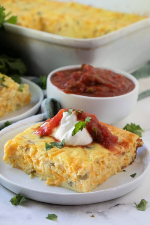 sliced of chilies rellenos bake on while plate