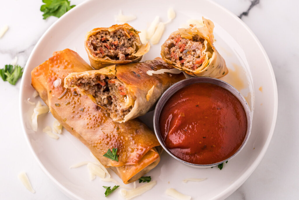 homemade pizza rolls with sauce on plate