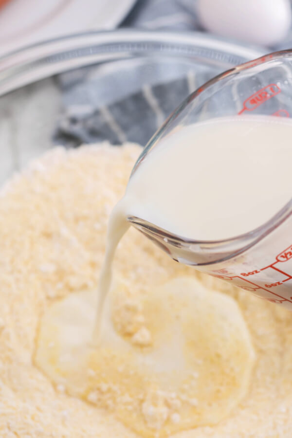 adding milk to the dry ingredients