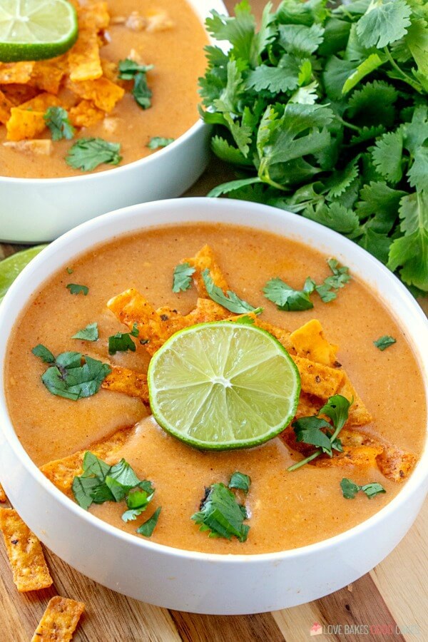 Chicken Enchilada Soup has chunks of chicken combined in a creamy, spicy enchilada soup base. Everything you love about chicken enchiladas - in soup form! Chicken Enchilada Soup in a bowl