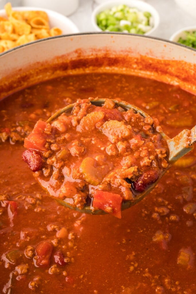 chili on ladle scooped out of pot