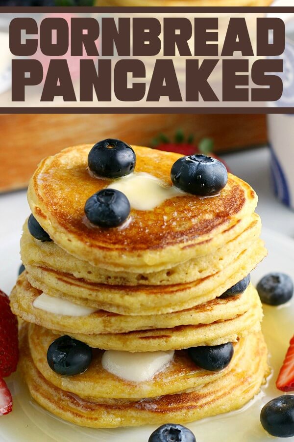 A stack of pancakes with blueberries and maple syrup.