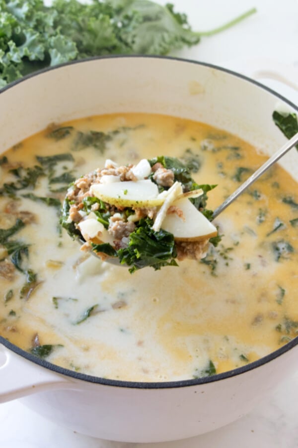 finished soup in pot with a scoop in the ladle