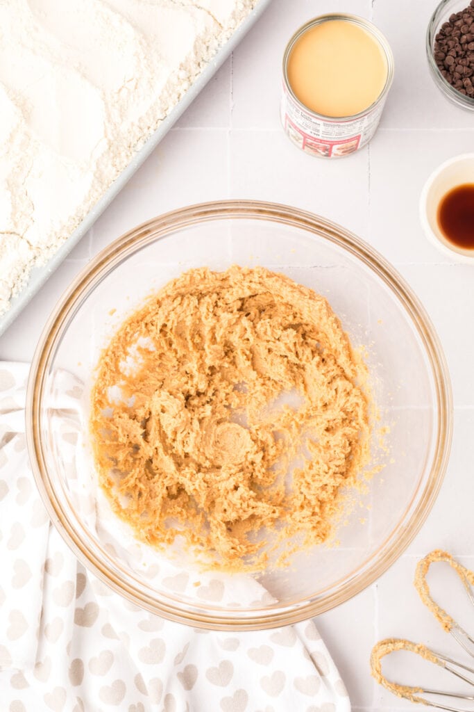 Creamed butter and brown sugar mixture in a glass bowl.