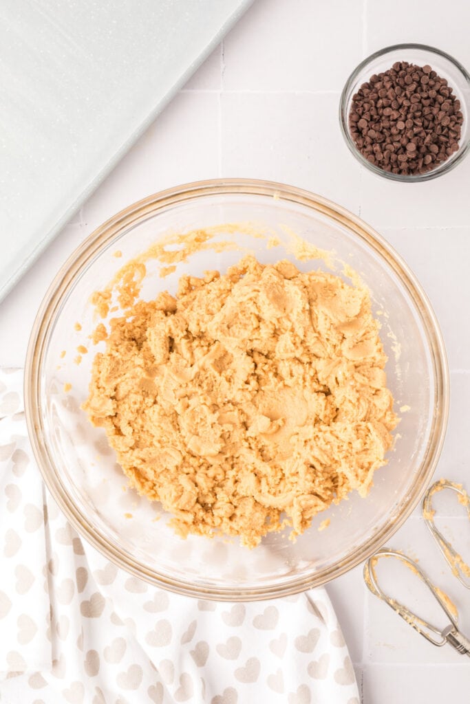 Cookie dough mixture combined in a bowl before adding chocolate chips.