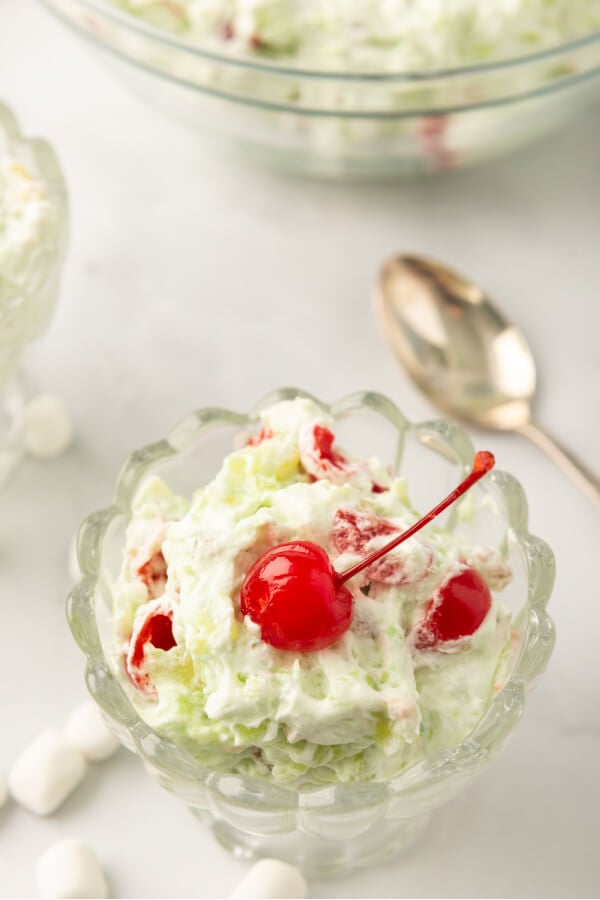 pistachio salad with maraschino cherries in serving bowl