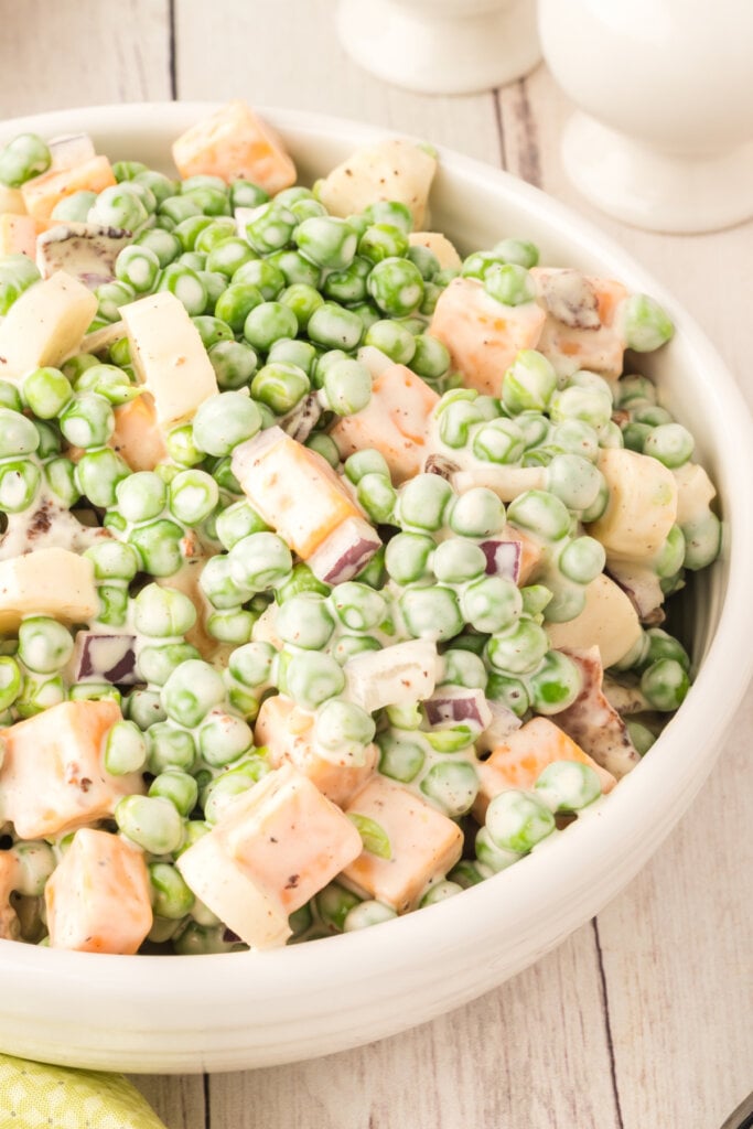 creamy pea salad with bacon in bowl
