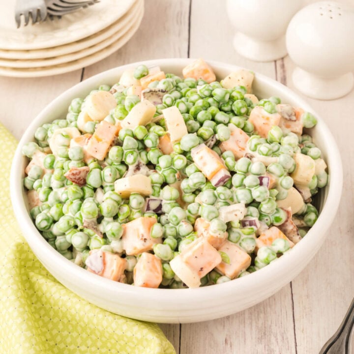 creamy pea salad in white bowl