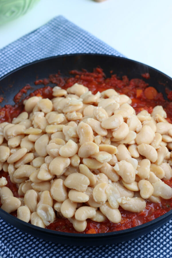 adding the soaked beans into the sauce