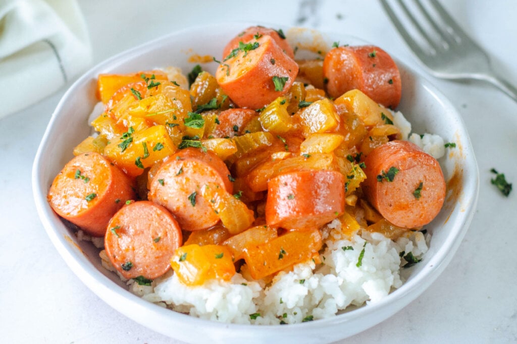 sweet & sour hot dogs over rice in bowl