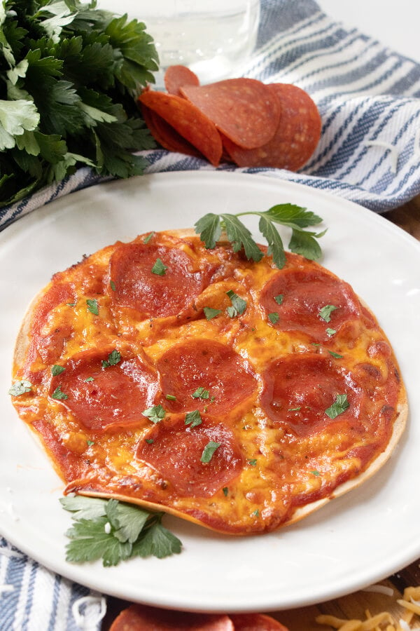 pepperoni tortilla pizza on white plate