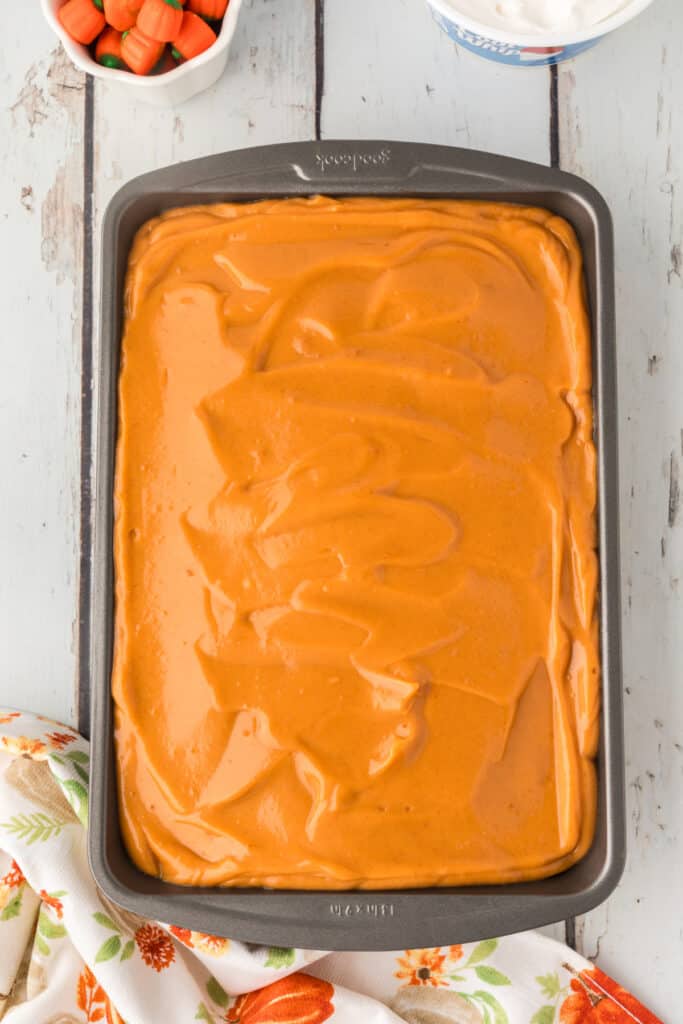 Pudding spread over the poked cake, ready to chill