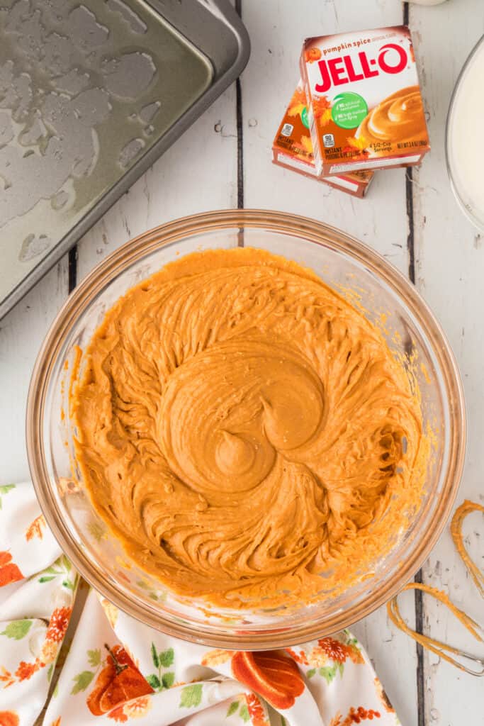 Pumpkin cake batter fully mixed in a clear glass bowl