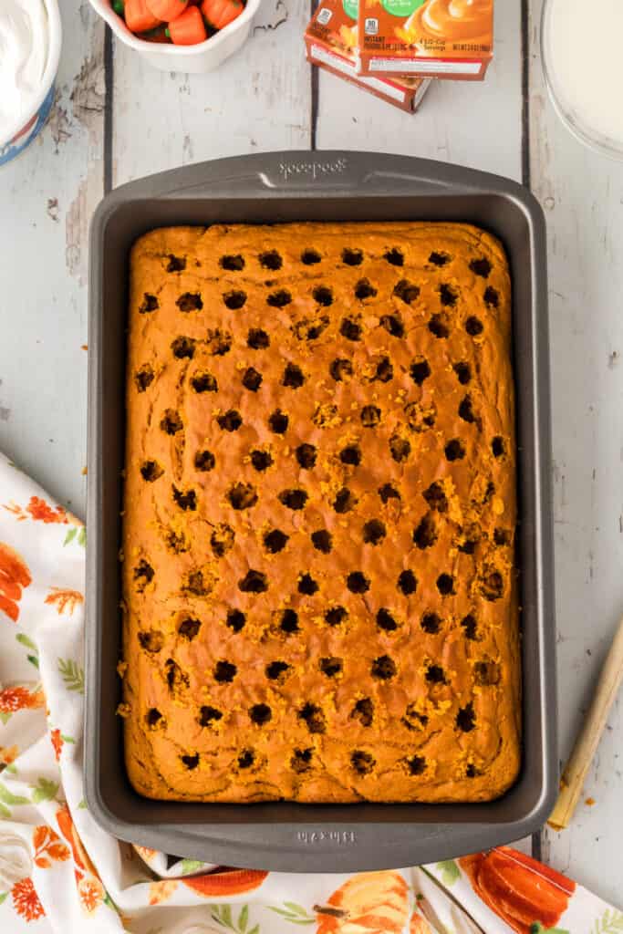 Baked cake with evenly spaced holes poked across the top