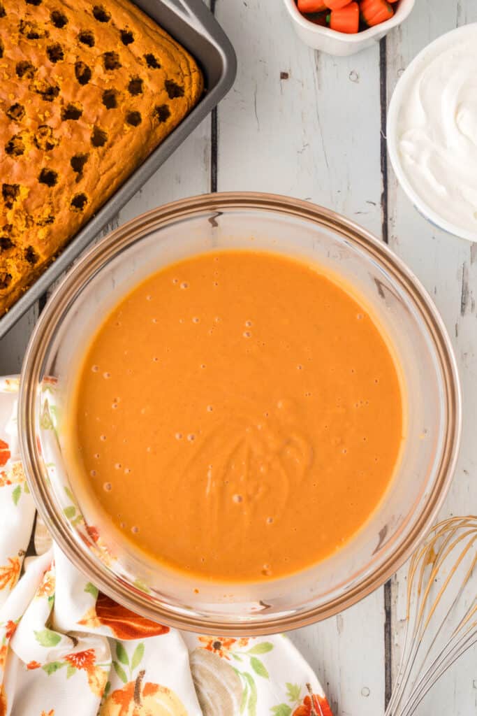 Smooth, fully whisked pumpkin pudding ready to pour over the cake