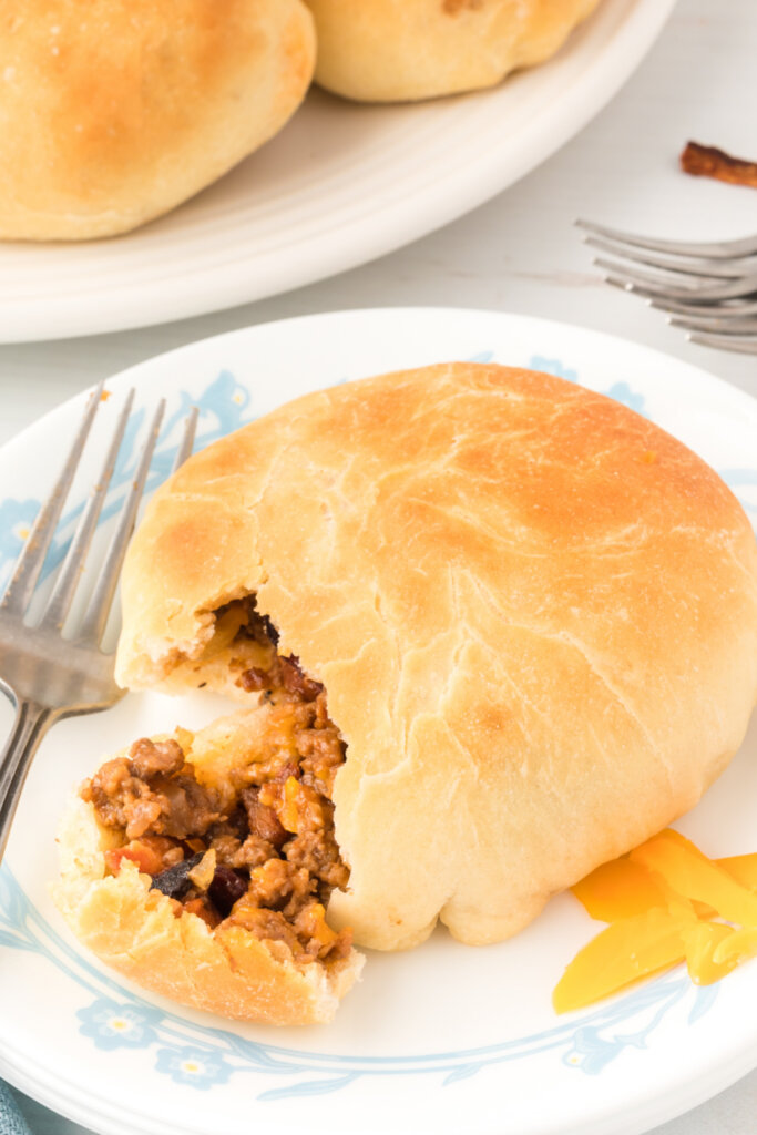 bbq bacon cheeseburger bun on plate with bite removed