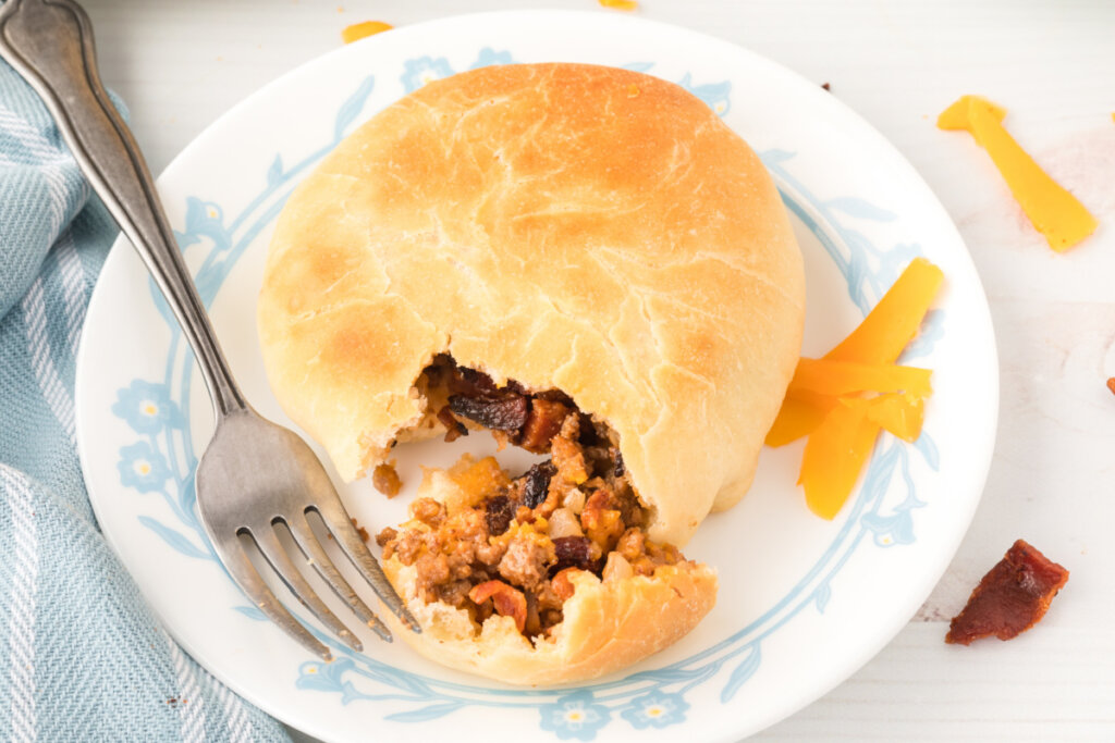 bbq bacon cheeseburger bun with bite removed to show the inside