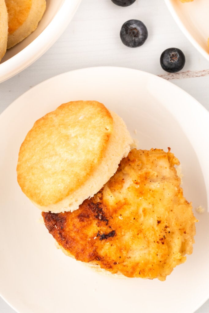 looking down onto fried chicken piece on split biscuit