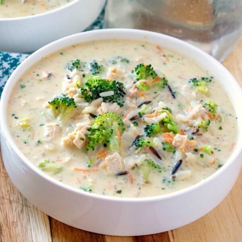 chicken broccoli and rice soup brimming in a creamy broth in bowl
