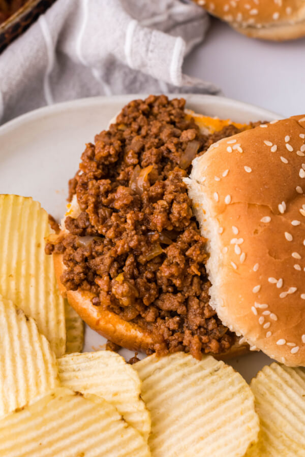 sloppy joes sauce with meat filling on bun and partially covered by the top bun