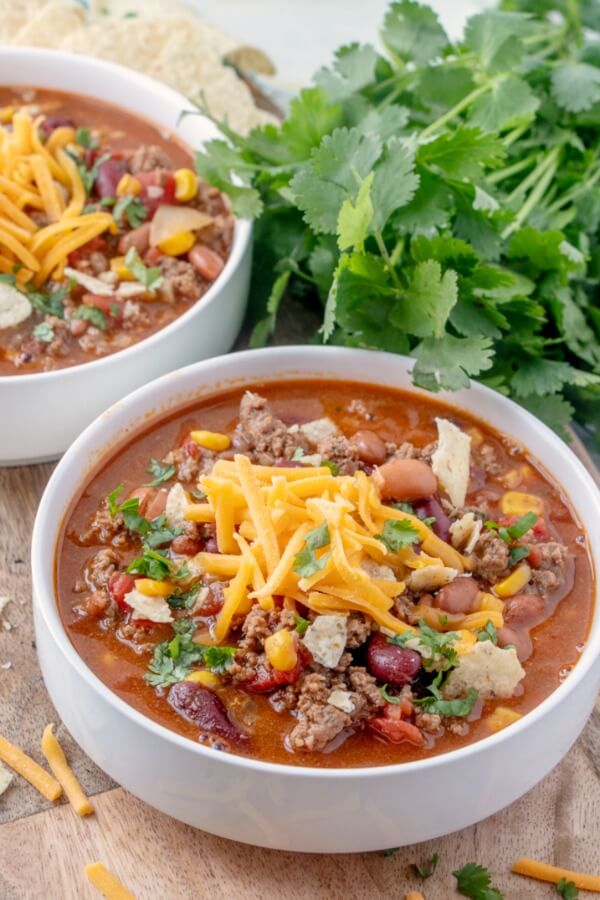 Taco Soup is a hearty and satisfying recipe with plenty of ground beef, beans, corn, and tomatoes in a zesty taco flavored broth. easy and hearty soup in bowl