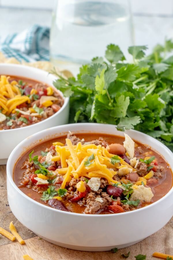 Taco Soup is a hearty and satisfying recipe with plenty of ground beef, beans, corn, and tomatoes in a zesty taco flavored broth. taco soup in bowl ready to eat