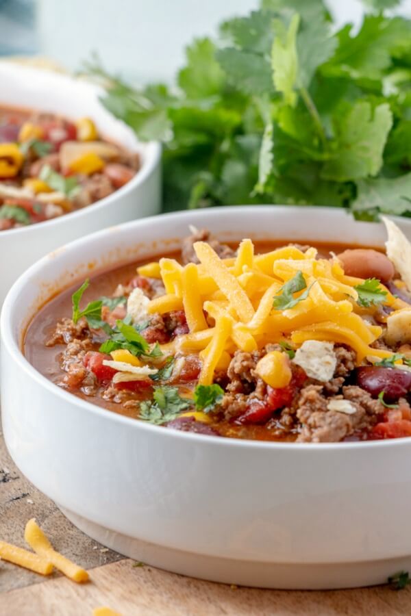 Taco Soup is a hearty and satisfying recipe with plenty of ground beef, beans, corn, and tomatoes in a zesty taco flavored broth. soup in a bowl