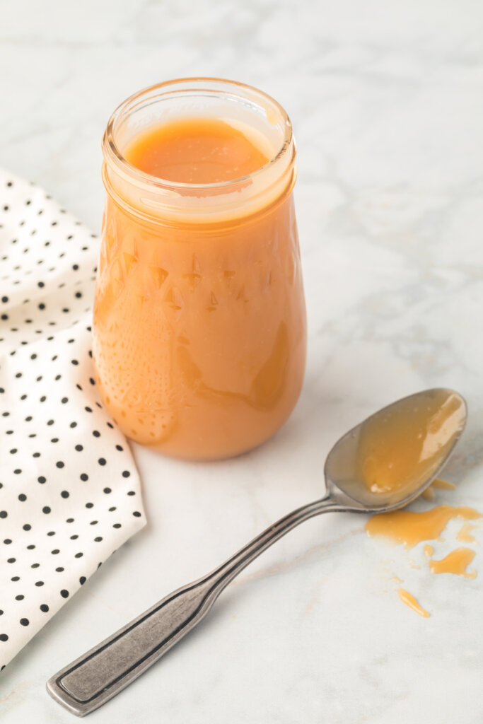 caramel sauce in jar with spoon