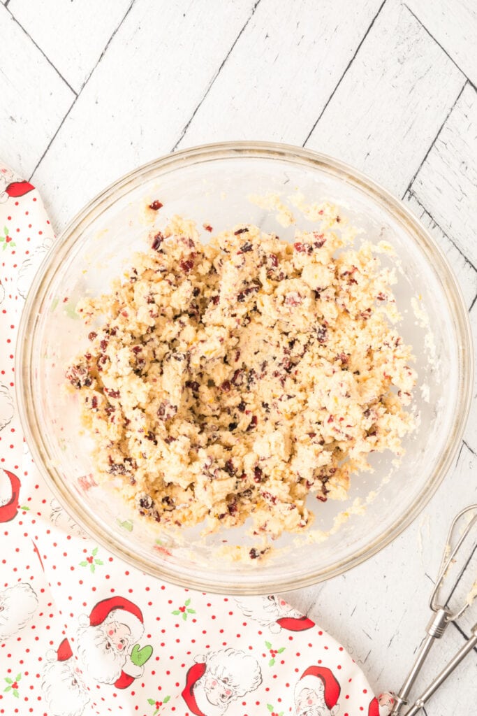 Fully mixed Cranberry Orange Christmas Sandies dough showing specks of cranberries and orange zest throughout.