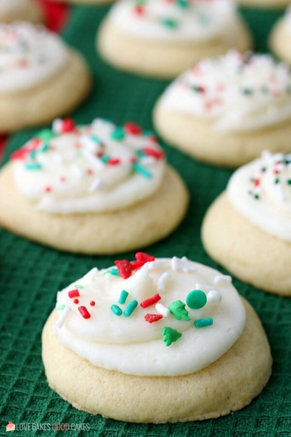 Soft Sugar Cookies with white frosting and red and green sprinkles on top.