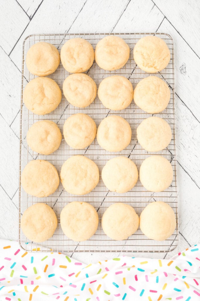 Baked soft sugar cookies cooling on a wire rack.