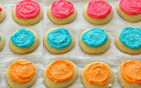 Soft Sugar Cookies laying on a cloth surface.