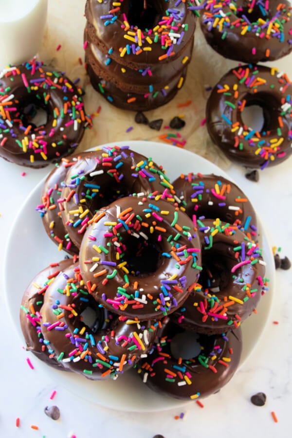 chocolate donuts with chocolate glaze on white plate
