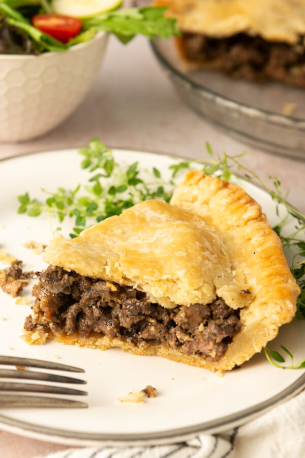 eating a slice of meat pie