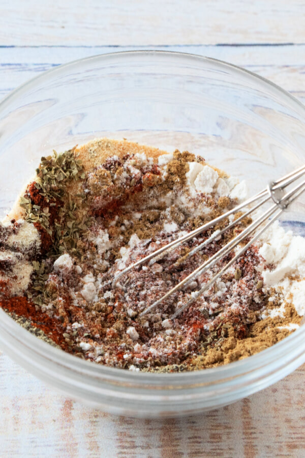 whisking together the spices in a glass bowl