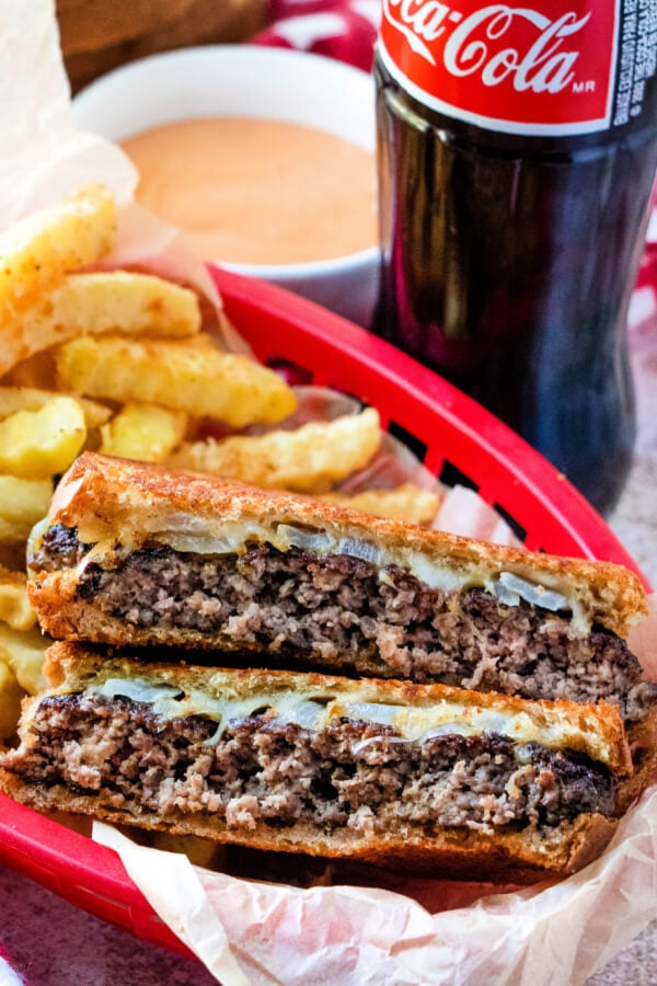 classic patty melts sandwich in red basket with fries