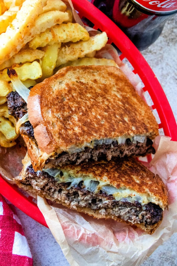 looking down into red basket with sandwich and fries