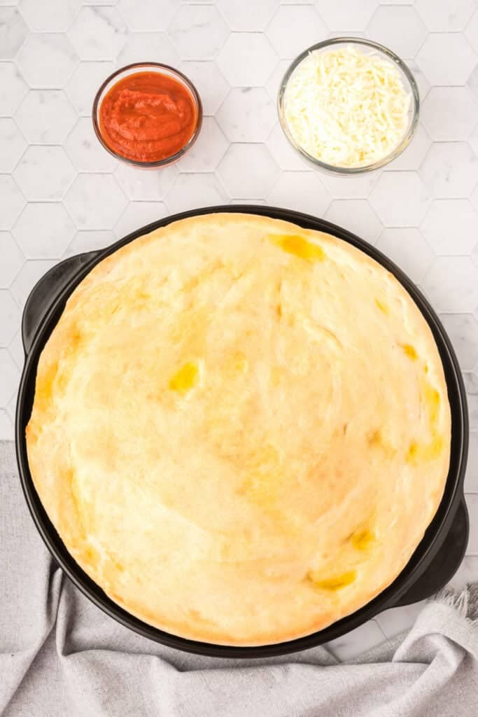 Prebaked homemade pizza crust made with Bread Machine Pizza Dough before adding toppings