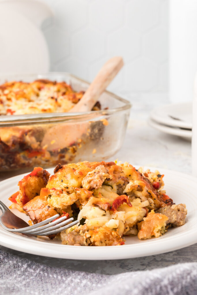 italian breakfast strata on plate with casserole dish in background