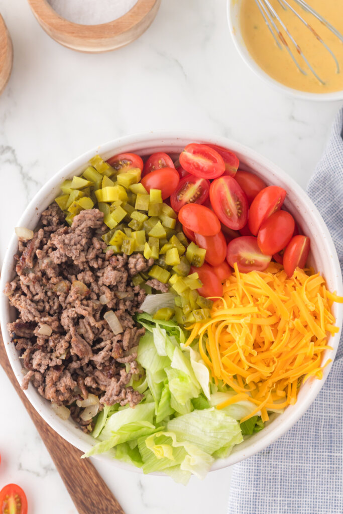 big mac salad in bowl before being mixed together