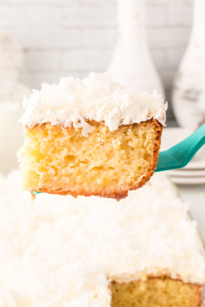 slice of cake on spatula over cake pan