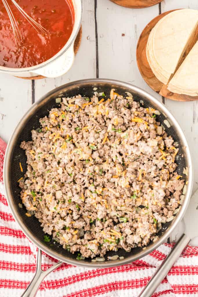 beef mixture stirred together in a skillet with melted cheese and sour cream