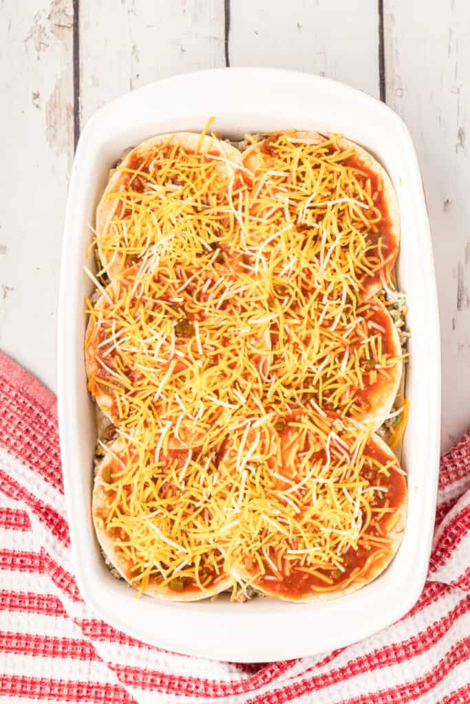 shredded cheese sprinkled over enchilada casserole before baking